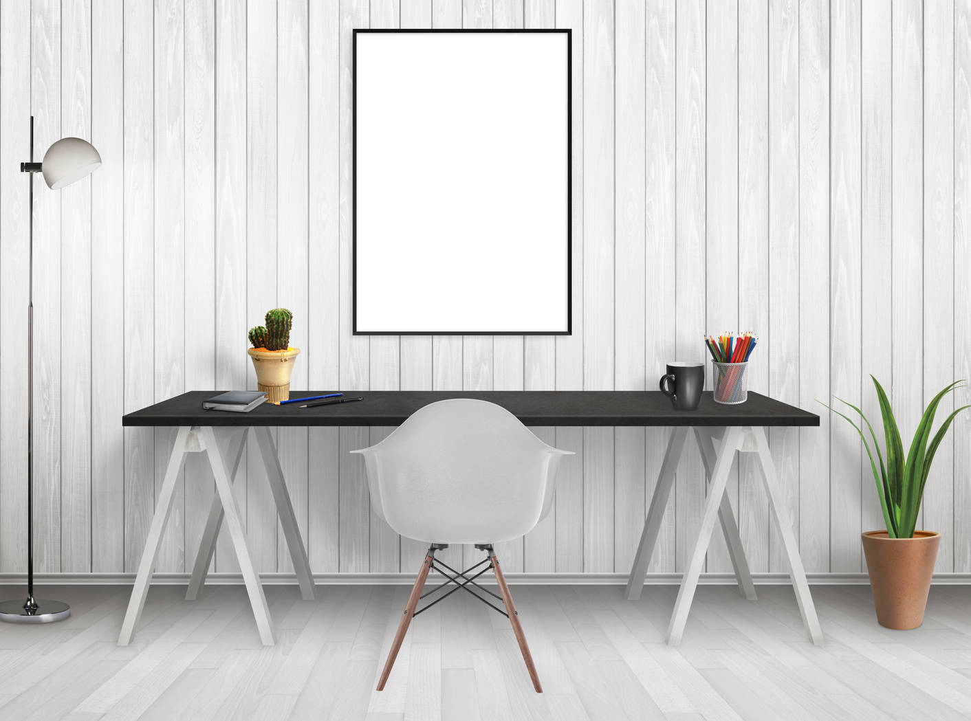 A desk with a black top and white leggs, and a white scoop chair