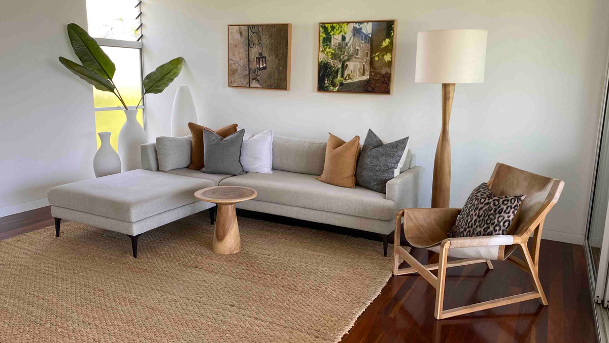 A bright and textural living room with a grey L-shaped couch