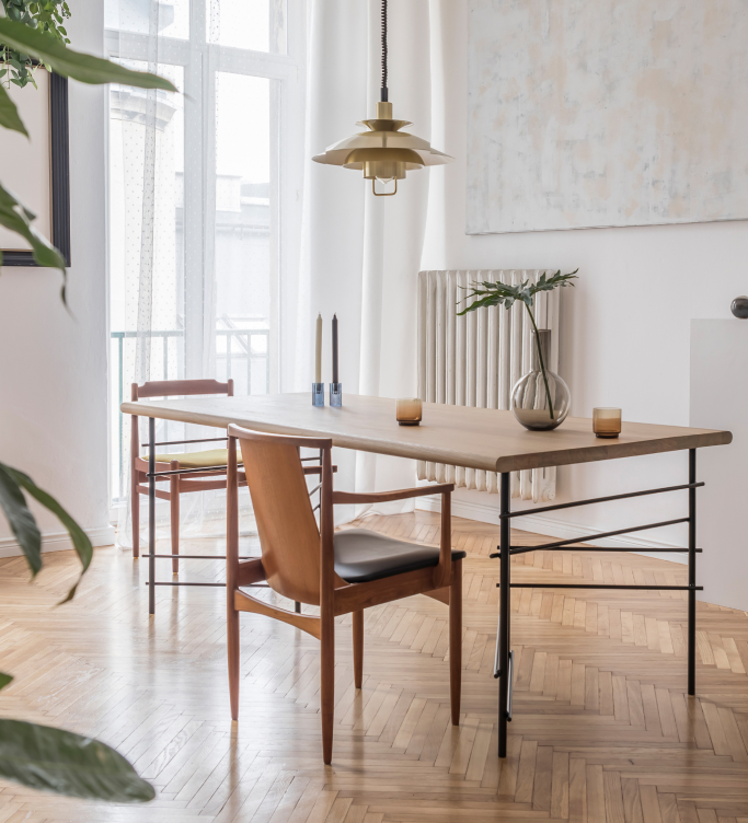 A bright dining room, with wooden accents and plants