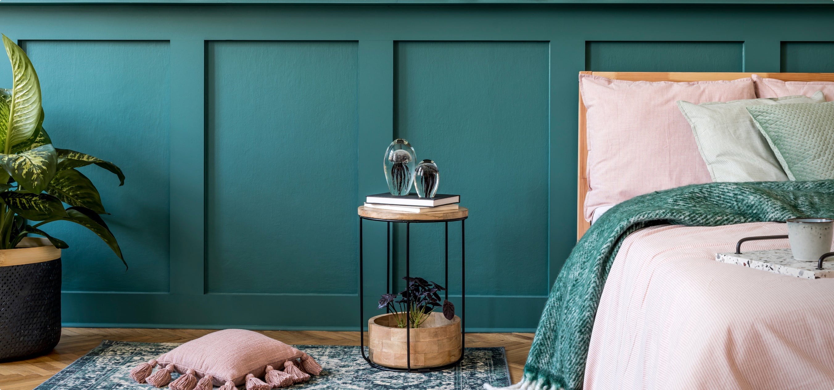 A gem tone green bedroom with a beautifully textured rug